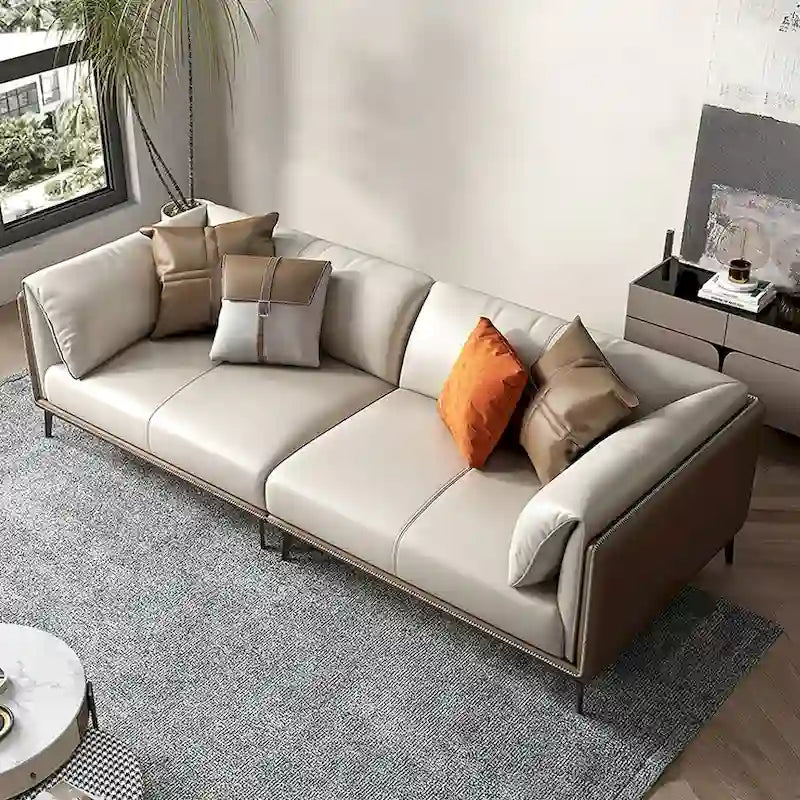 Canapé deux places avec accoudoirs rembourrés en similicuir et coussins réversibles